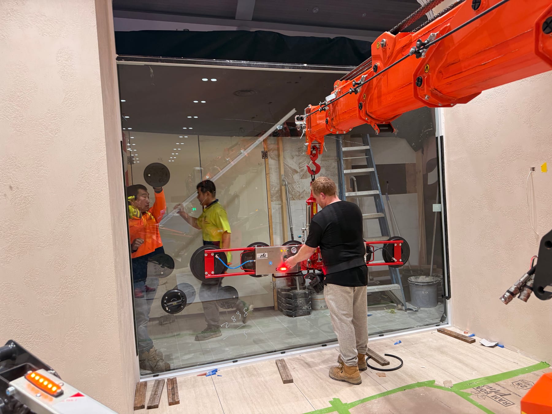 Shopfront glass installation using lifting equipment and suction lifter
